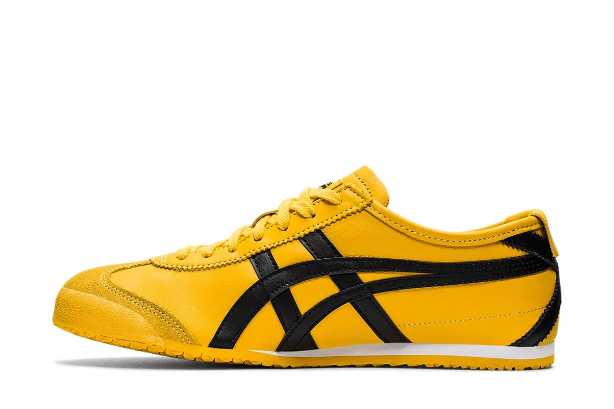 Tênis amarelo com detalhes pretos, estilo retrô, solado baixo, moderno e casual.