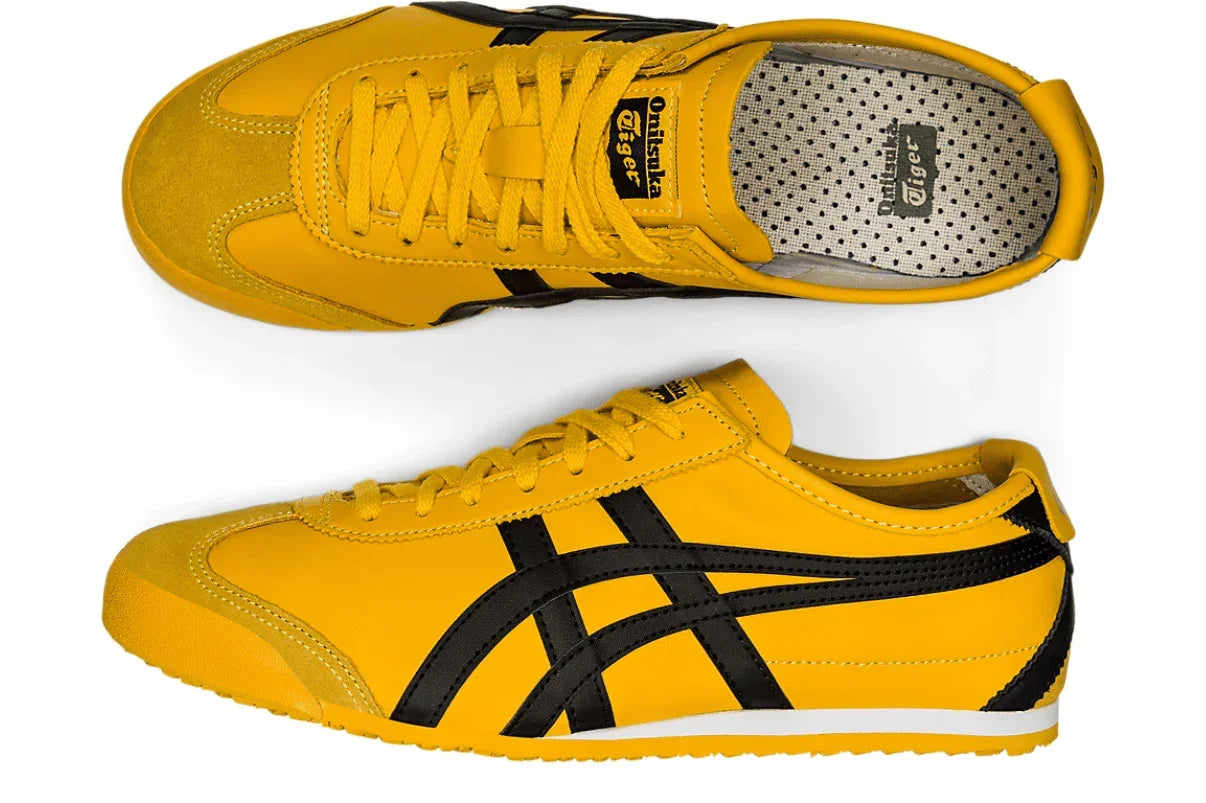 Tênis amarelo com detalhes pretos, estilo retrô, design clássico, visual moderno e esportivo.