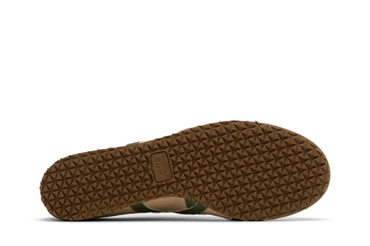 Sola de tênis marrom com textura geométrica e logo Onitsuka Tiger em destaque.