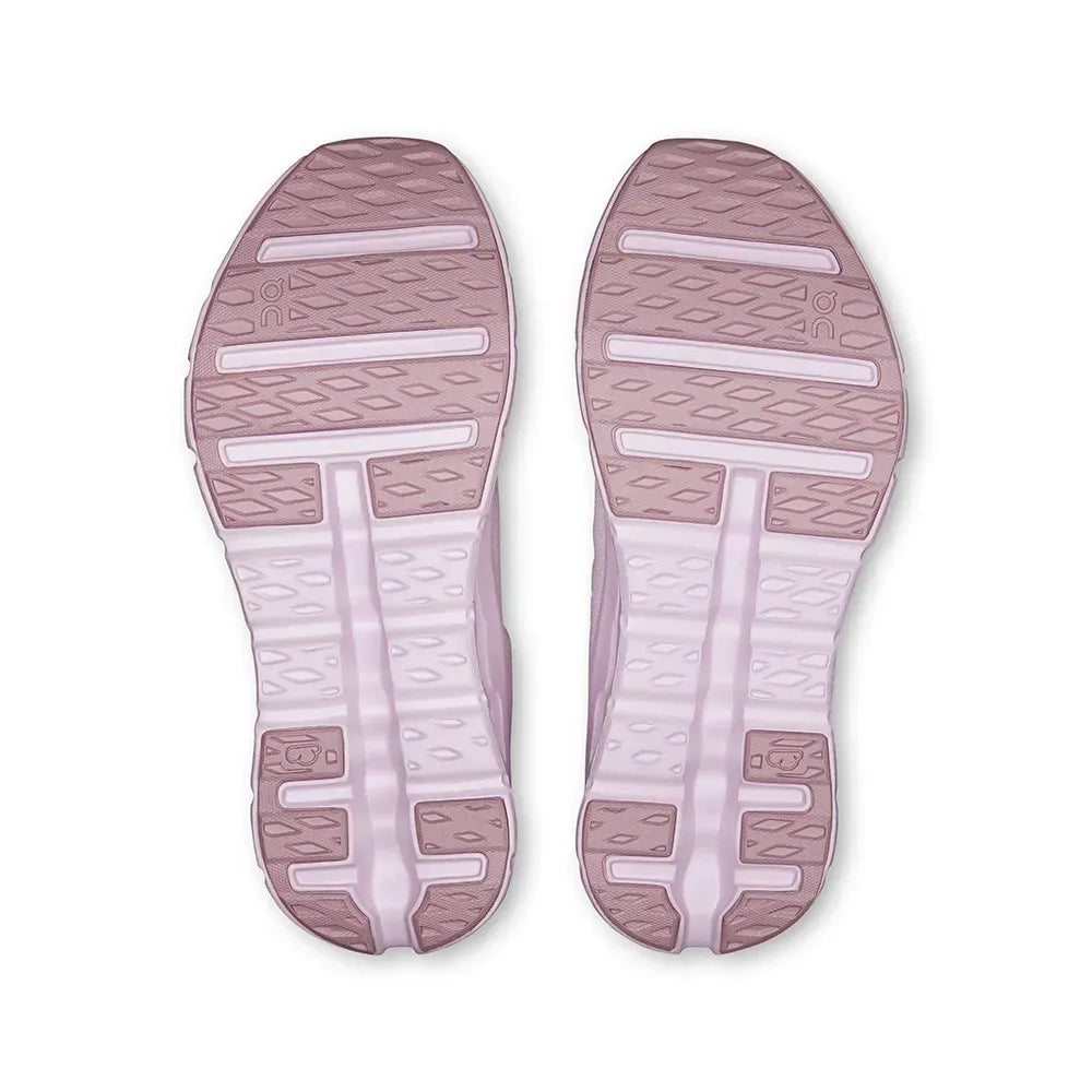 Sola dos tênis esportivos rosa claro com detalhes texturizados e design antiderrapante.