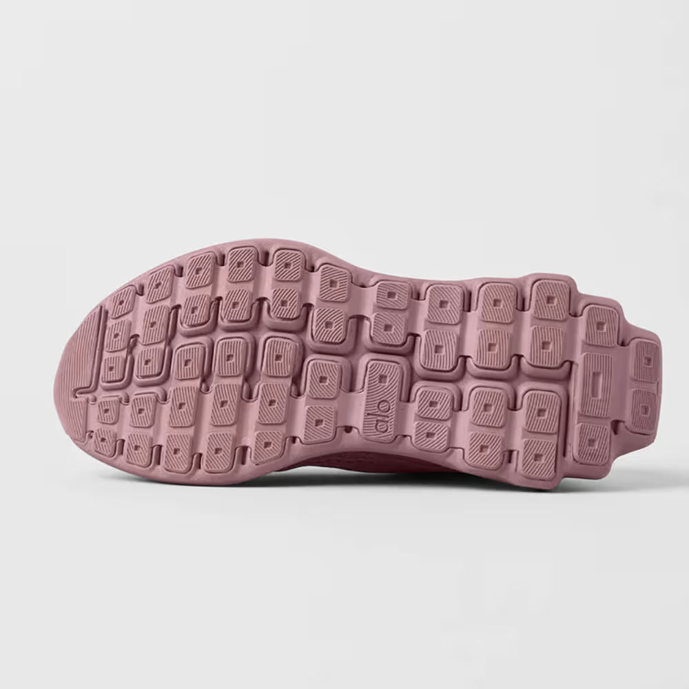Solado de tênis esportivo rosa antigo com design texturizado visto de baixo