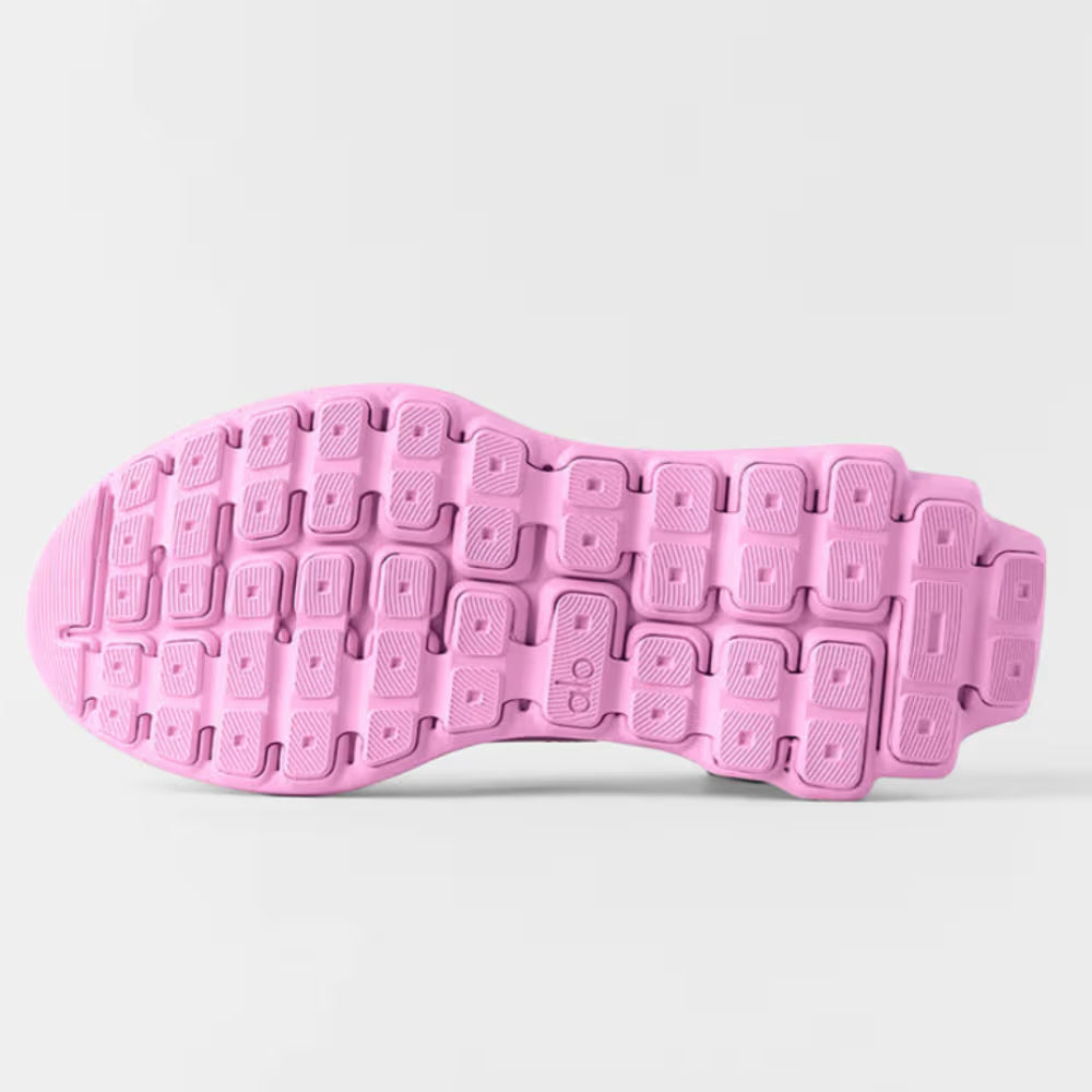 Solado rosa de tênis esportivo com design anatômico e textura antiderrapante, fundo branco.