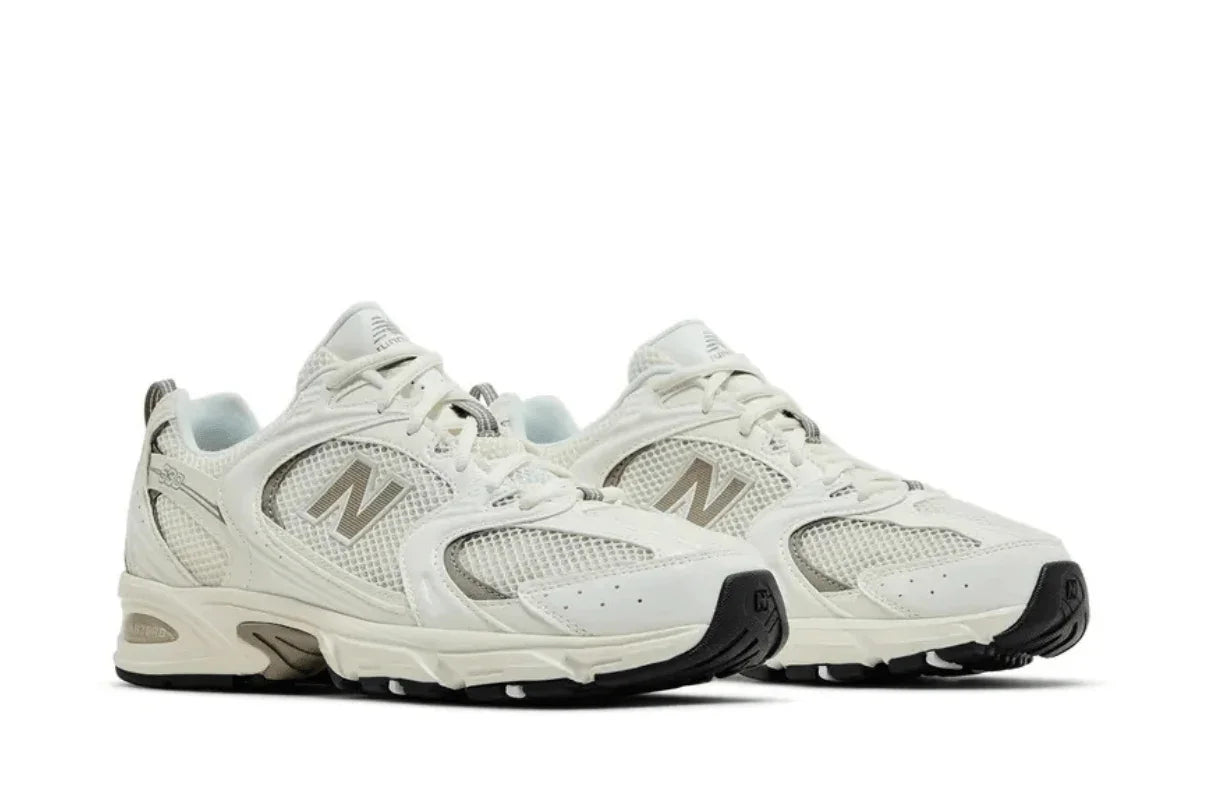 Tênis casual branco e cinza com detalhes em mesh e solado robusto, visual moderno.