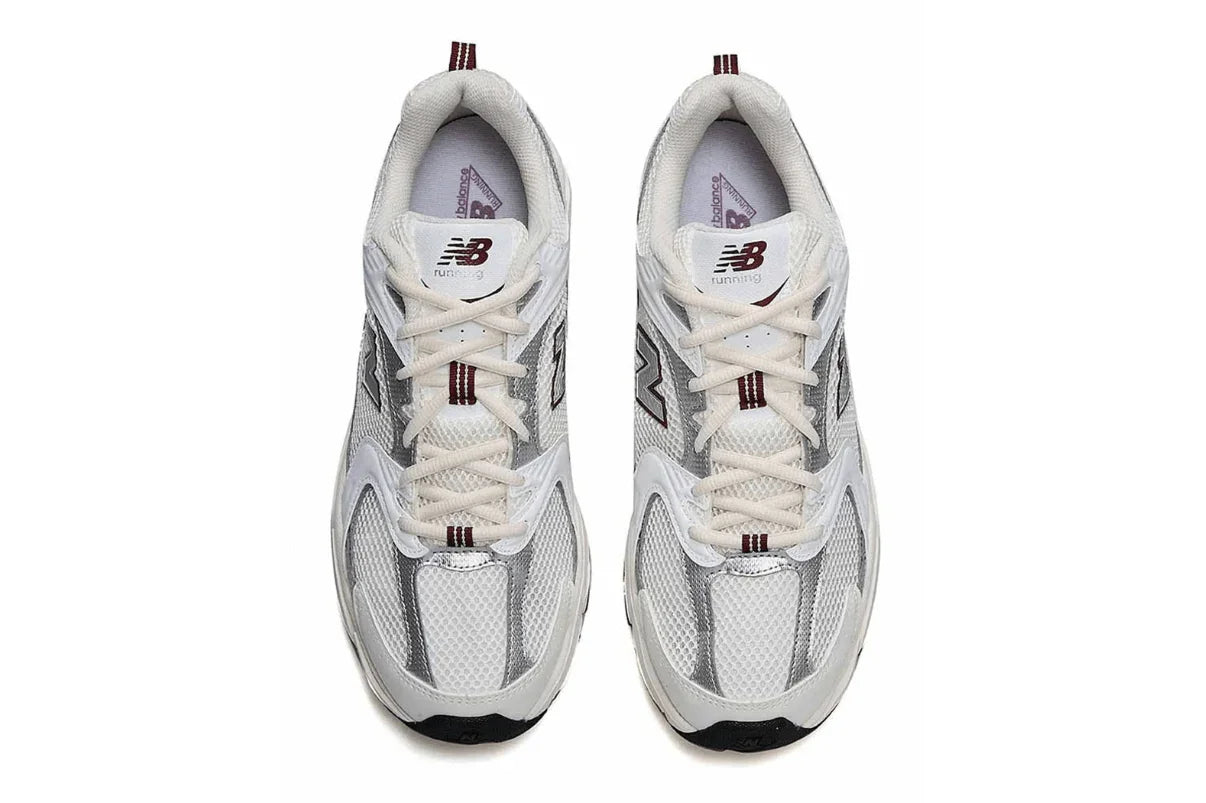 Tênis esportivo branco e cinza com detalhes em mesh e listras vinho, visto de cima, estilo running.