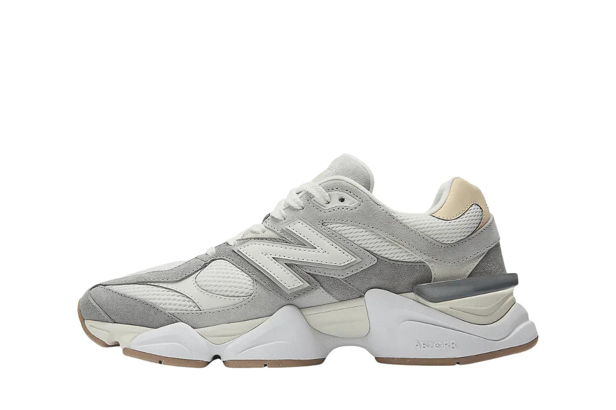 Tênis esportivo masculino cinza e branco com detalhes em mesh e solado robusto.