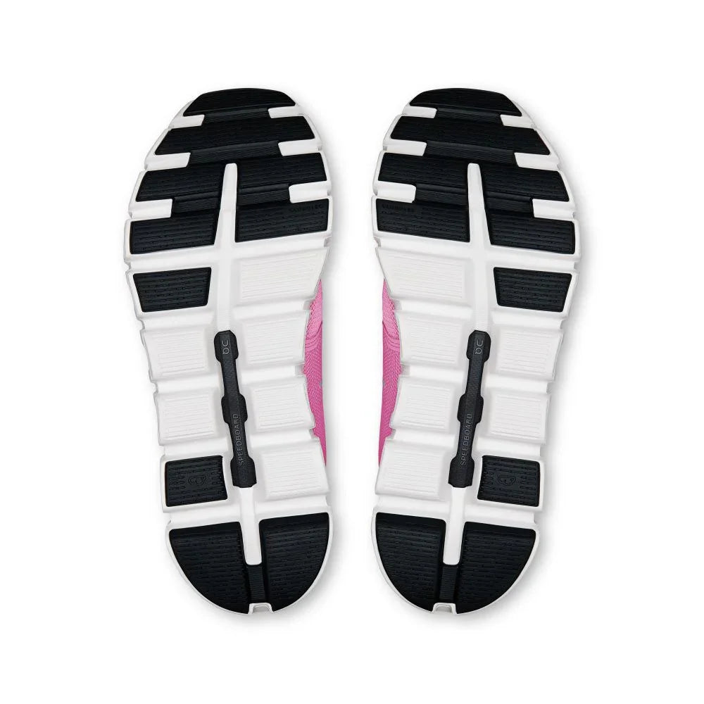 Solado de tênis esportivo rosa com detalhes em preto e branco visto de baixo.