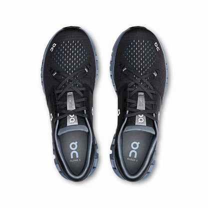 Tênis esportivo preto com detalhes azul claro, visto de cima, design respirável e moderno.