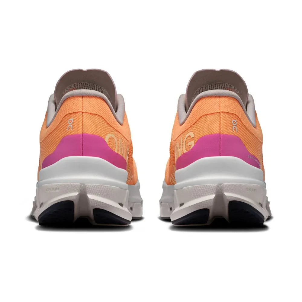 Tênis esportivo laranja com detalhes rosa e solado branco, visto de trás, modelo running.