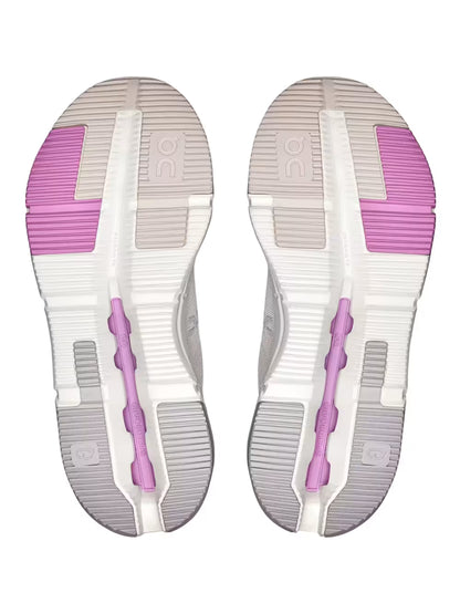 Solado de tênis branco com detalhes rosa e cinza, padrão esportivo moderno.