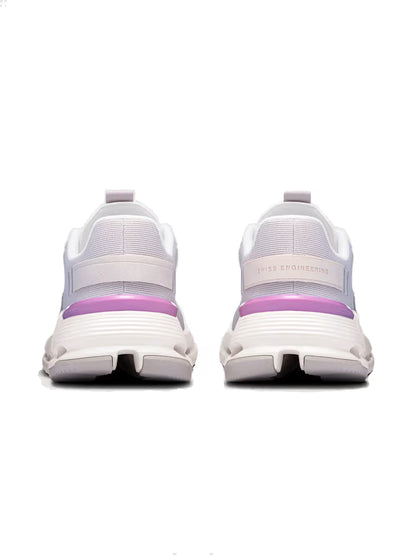 Tênis esportivo branco e rosa visto de trás, com sola robusta e detalhes de malha.