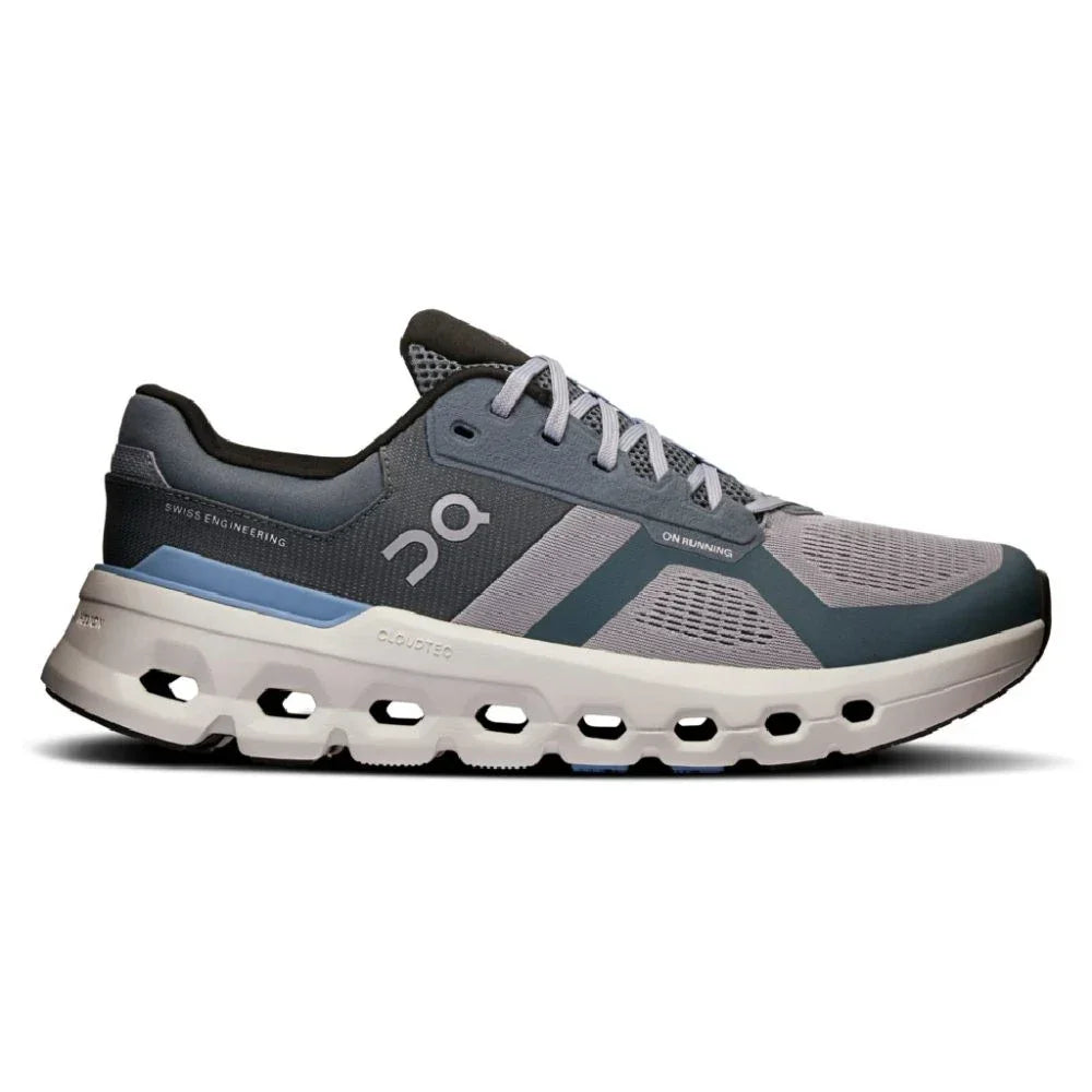 Tênis esportivo cinza com detalhes azul celeste, solado robusto e design moderno.