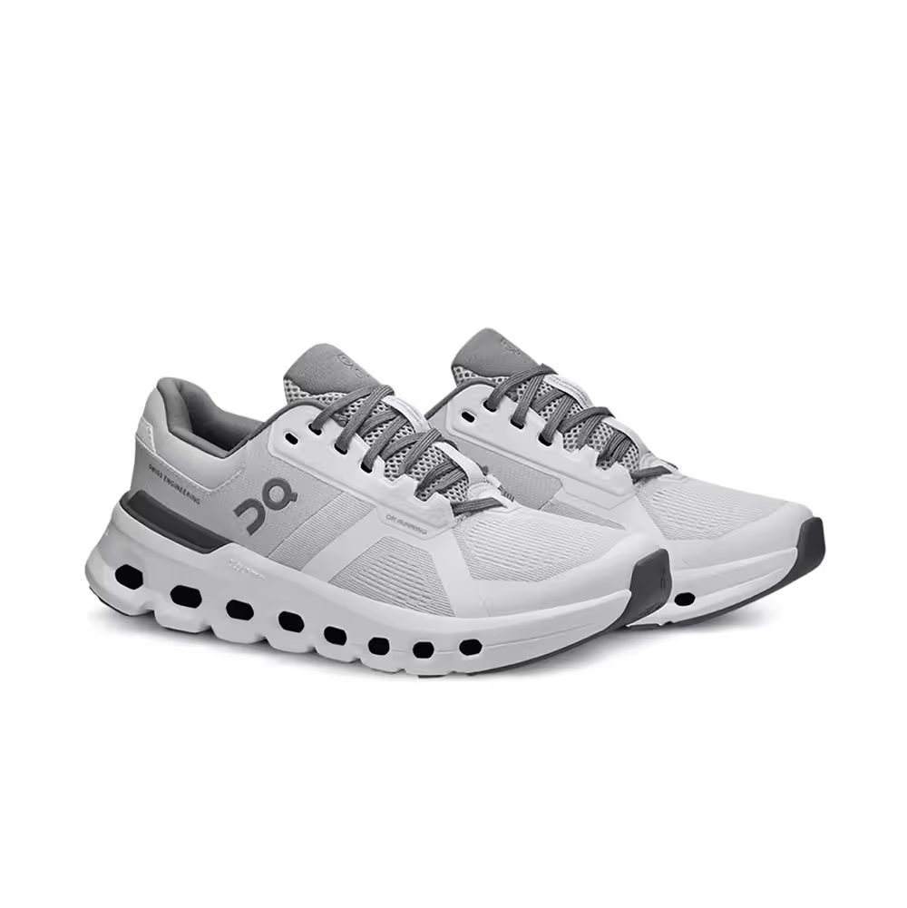 Tênis esportivo cinza e branco com solado robusto, design moderno e recortes em mesh.