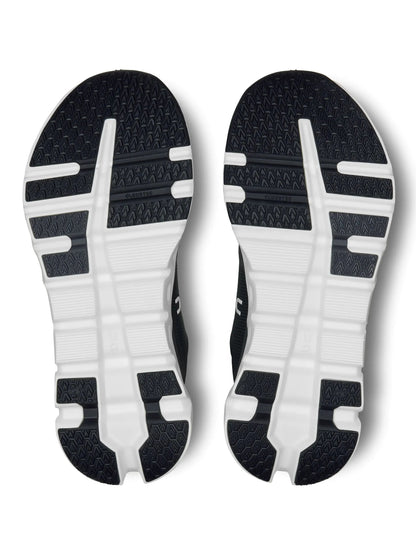 Solado do tênis On Running Cloudrunner 2 preto e branco com base estruturada e elementos vazados característicos